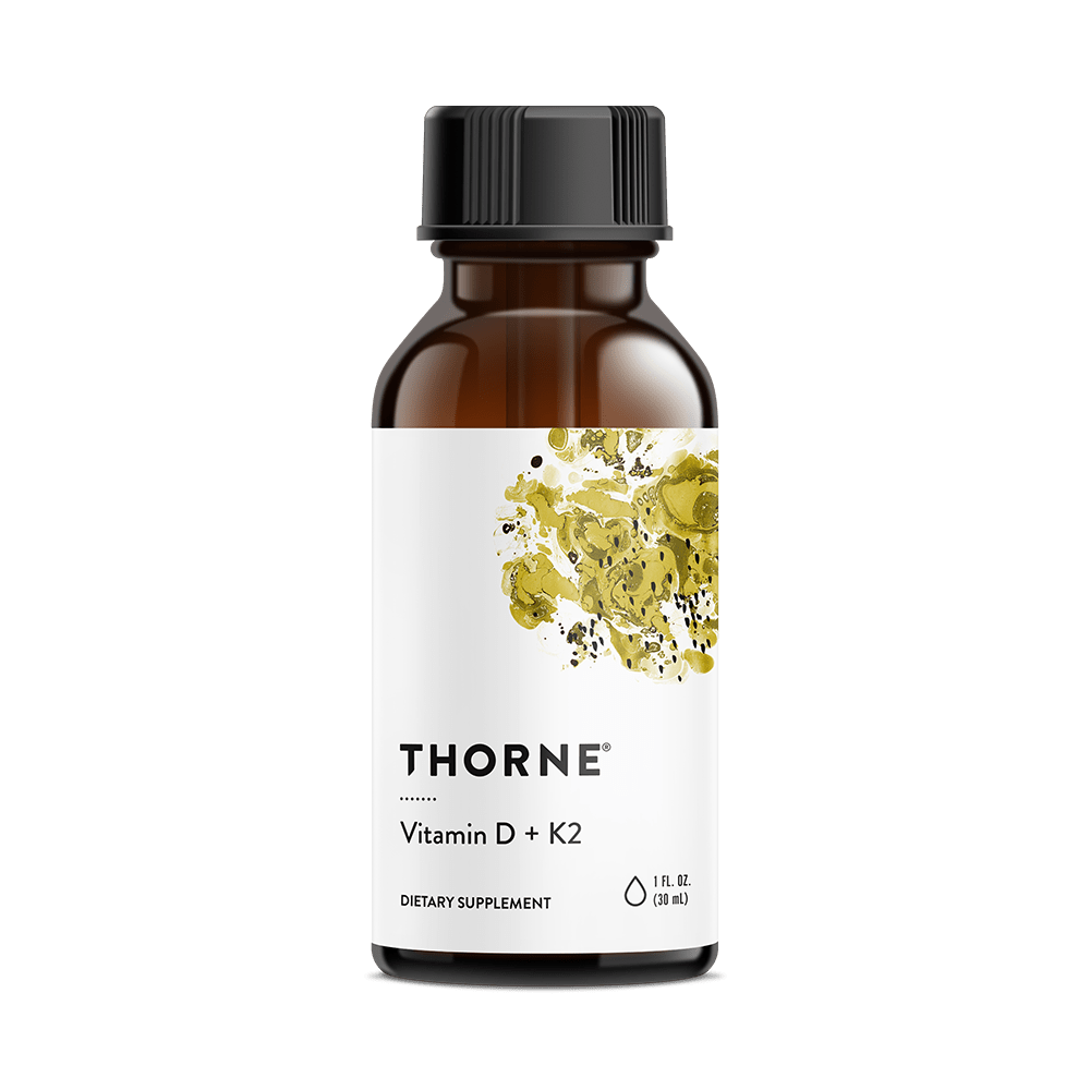 Thorne Vitamin D + K2 dietary supplement bottle on a green background